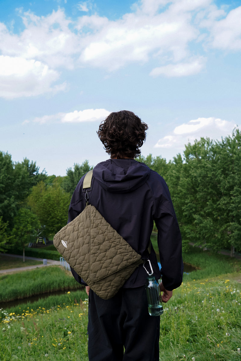Model wearing FFUJJI Portra Bag on a hill looking at nature.